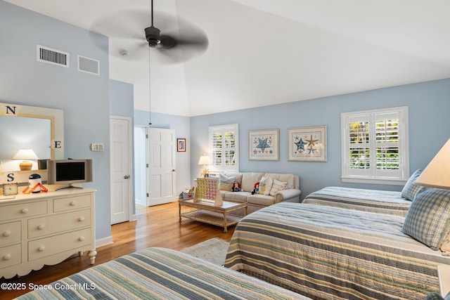 bedroom with lofted ceiling, ceiling fan, and light hardwood / wood-style floors