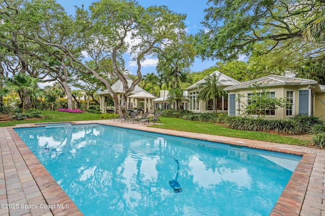 view of swimming pool featuring a gazebo and a yard