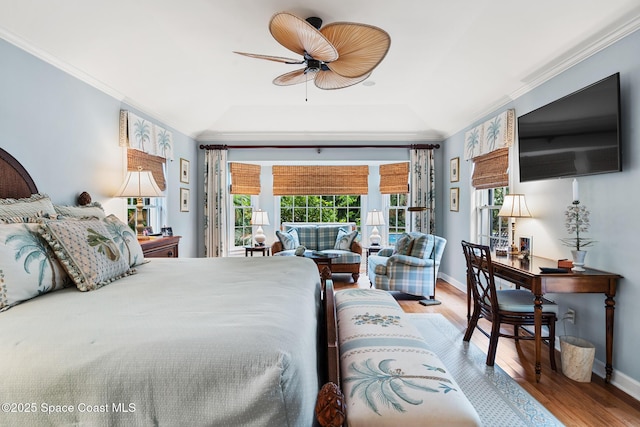 bedroom featuring lofted ceiling, hardwood / wood-style floors, ceiling fan, and ornamental molding