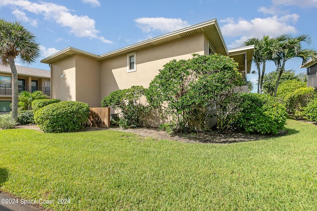 view of side of property with a lawn