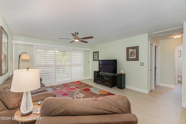 living room featuring ceiling fan and light hardwood / wood-style flooring