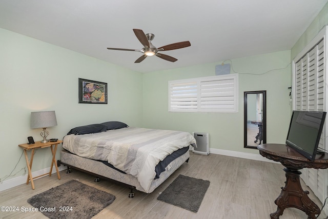 bedroom with light wood-type flooring and ceiling fan