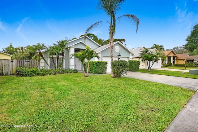 view of front of home with a front yard and a garage