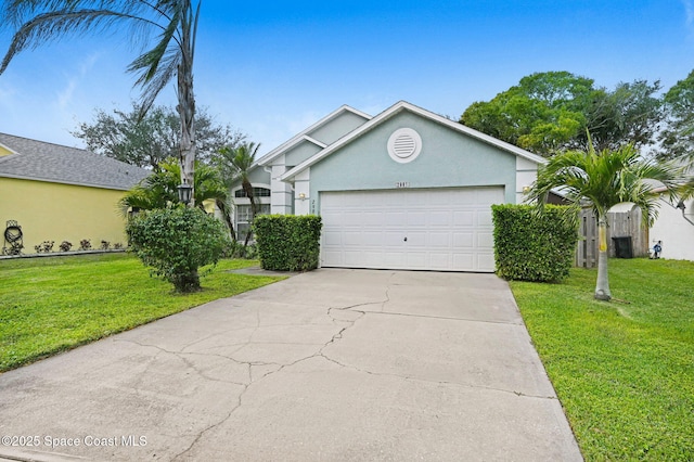 ranch-style house featuring a front yard and a garage