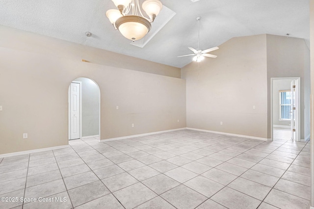 tiled spare room with high vaulted ceiling and ceiling fan with notable chandelier