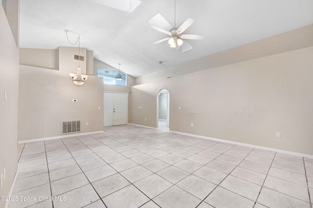 unfurnished living room with high vaulted ceiling, light tile patterned flooring, and ceiling fan