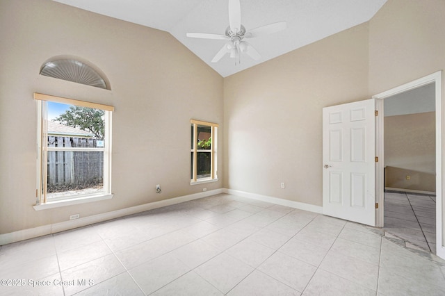 tiled empty room featuring high vaulted ceiling and ceiling fan