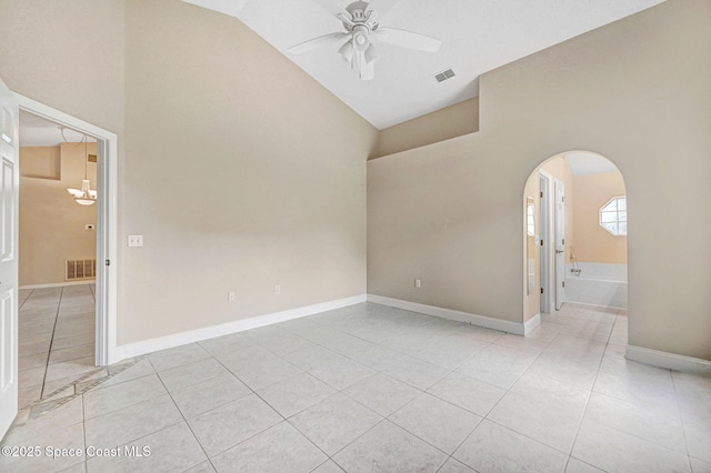 tiled empty room featuring ceiling fan with notable chandelier and lofted ceiling