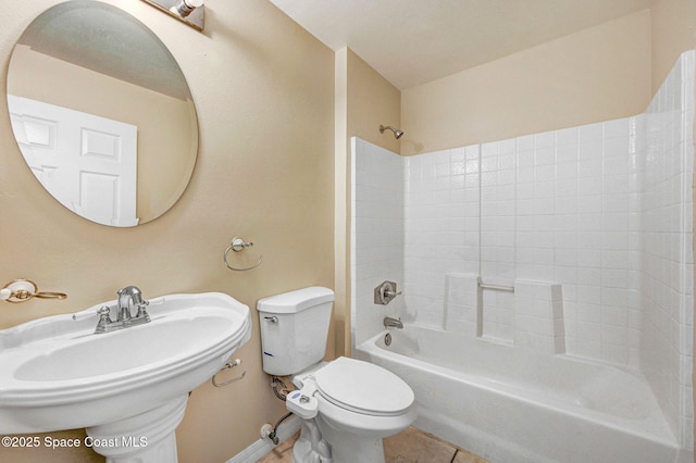 full bathroom featuring toilet, tile patterned floors, shower / bathtub combination, and sink