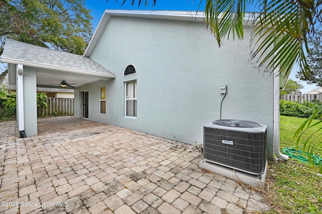 exterior space with a patio, central air condition unit, and ceiling fan