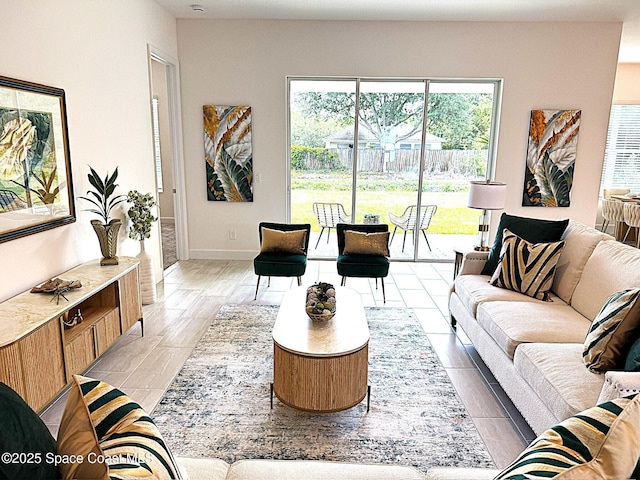 living room with baseboards and plenty of natural light