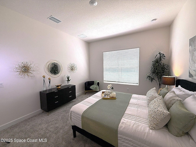 bedroom featuring visible vents, a textured ceiling, baseboards, and light carpet
