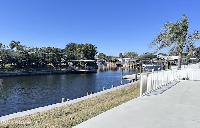 property view of water featuring boat lift and a dock