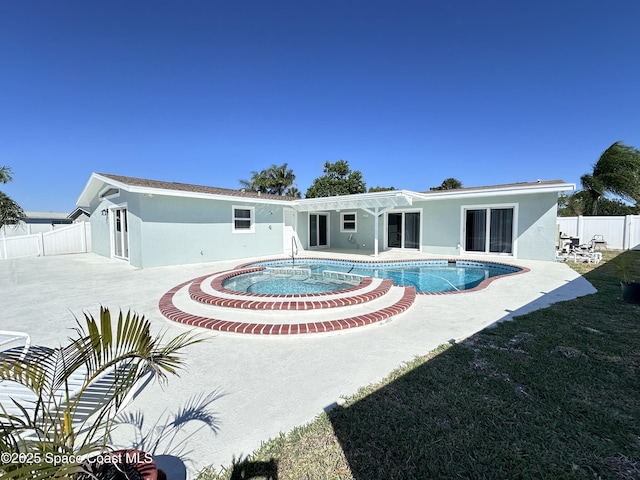 back of property featuring a patio, fence, a fenced in pool, a yard, and stucco siding