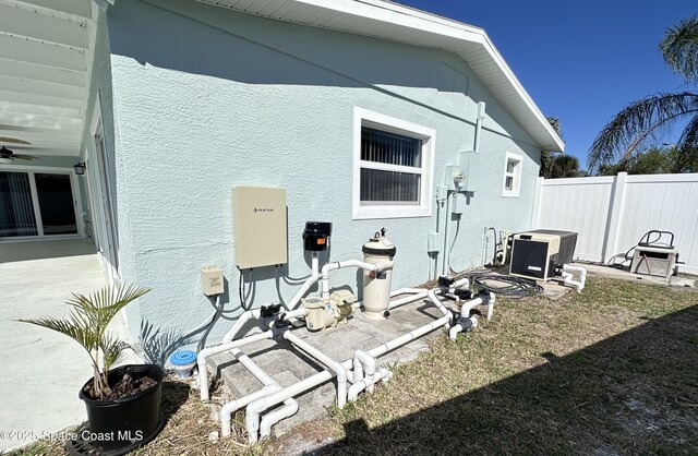 back of house with stucco siding, a patio, ceiling fan, and fence