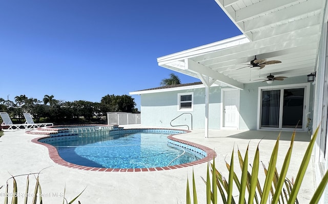 outdoor pool featuring a patio and a ceiling fan