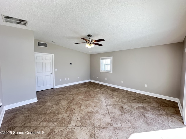 spare room with visible vents, baseboards, a textured ceiling, and a ceiling fan