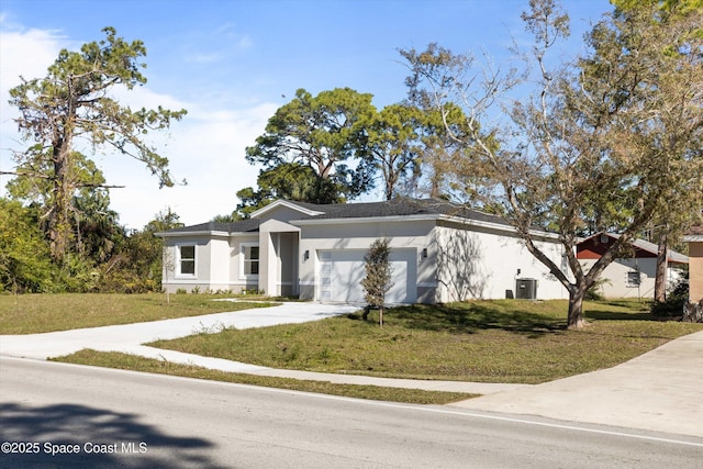 view of front of house featuring central AC unit, a front lawn, and a garage