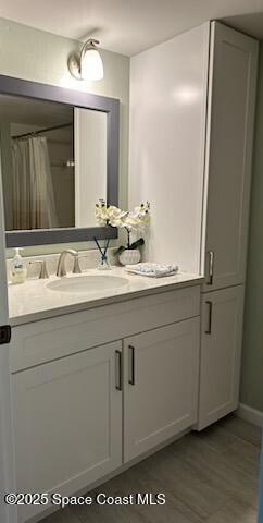 bathroom with tile patterned floors, vanity, and a shower with curtain