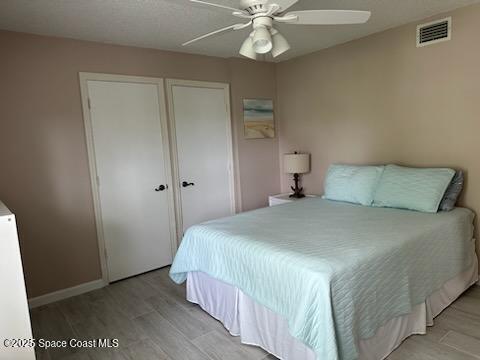 bedroom featuring ceiling fan and light hardwood / wood-style flooring