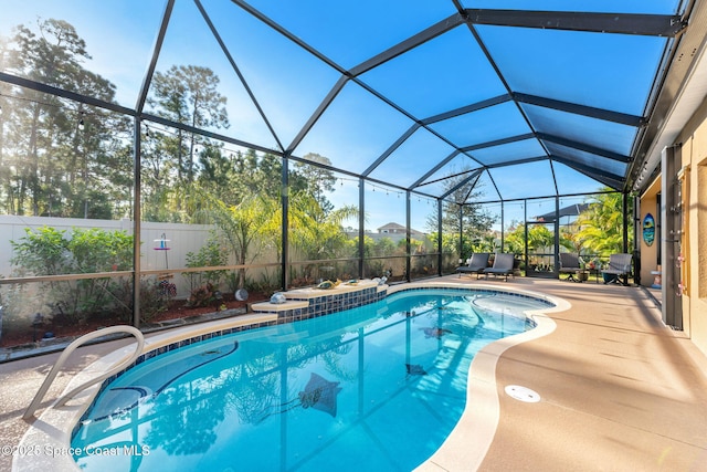 view of pool with a patio and glass enclosure