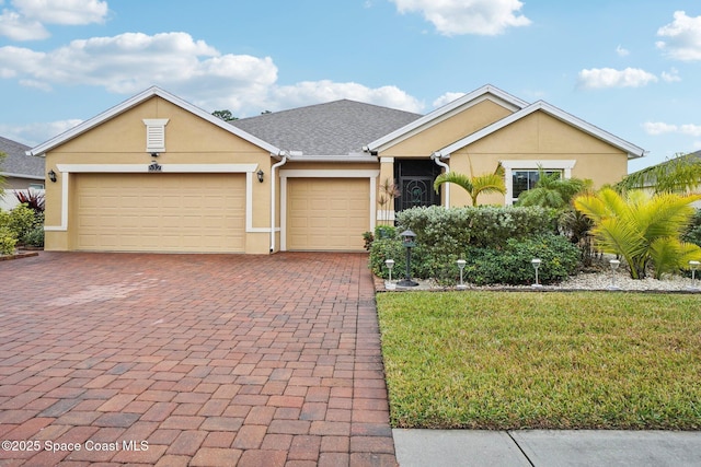 view of front of home featuring a garage and a front lawn