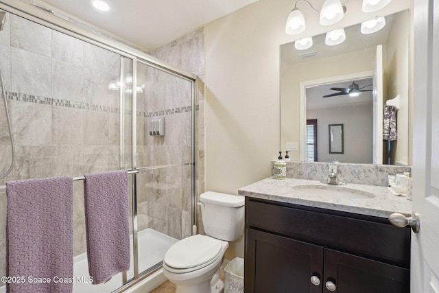 bathroom with vanity, ceiling fan, toilet, and walk in shower