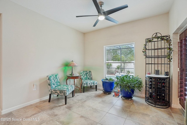 sitting room featuring light tile patterned floors and ceiling fan