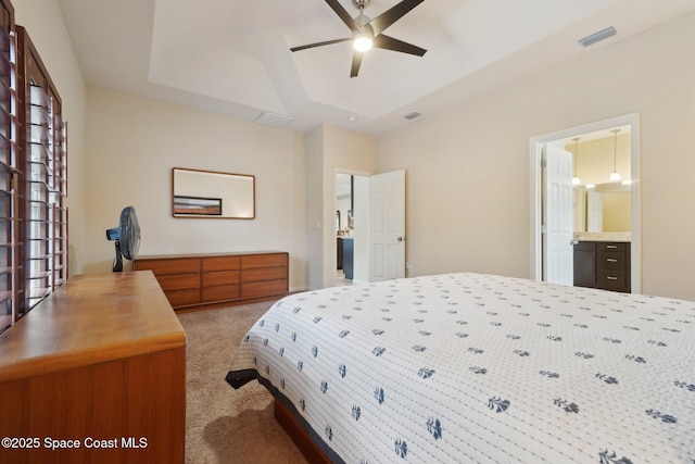 carpeted bedroom with ceiling fan and ensuite bathroom