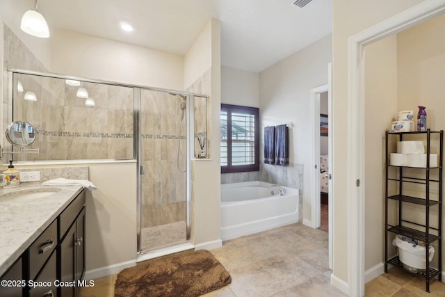 bathroom featuring tile patterned flooring, plus walk in shower, and vanity