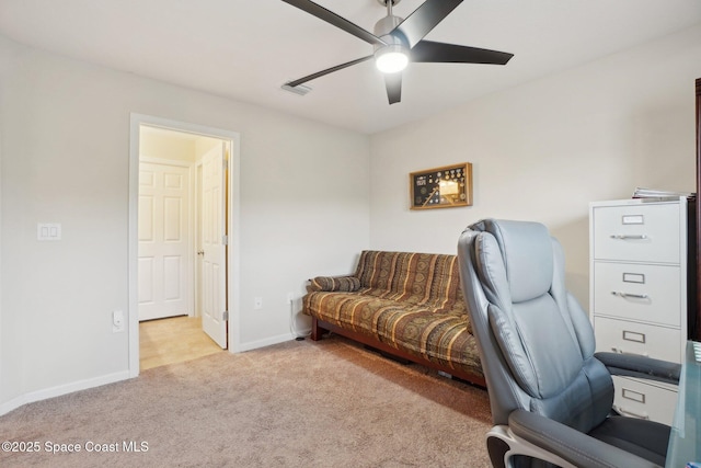 office space featuring light carpet and ceiling fan