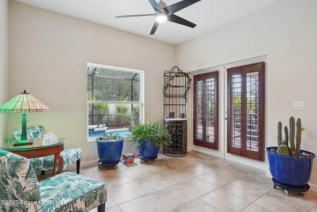 sitting room featuring french doors, ceiling fan, and light tile patterned flooring