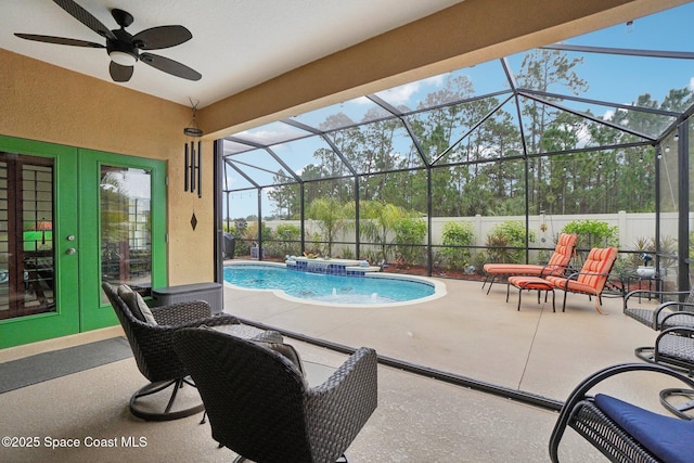 view of swimming pool with a lanai, ceiling fan, a patio area, french doors, and pool water feature