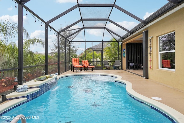 view of pool featuring pool water feature, a patio area, and a lanai