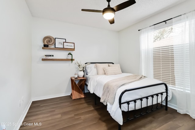 bedroom featuring ceiling fan and dark wood-type flooring