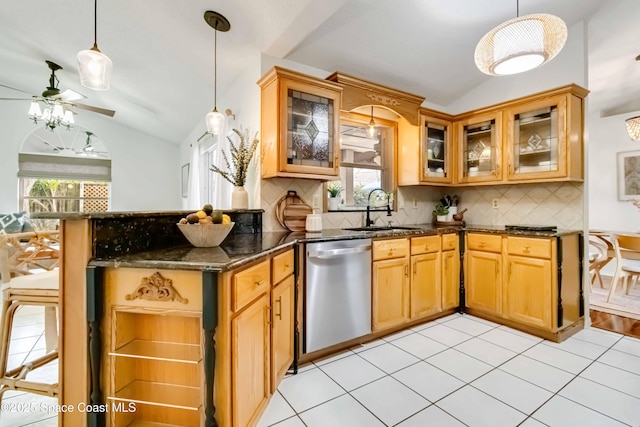 kitchen with ceiling fan, sink, stainless steel dishwasher, and vaulted ceiling