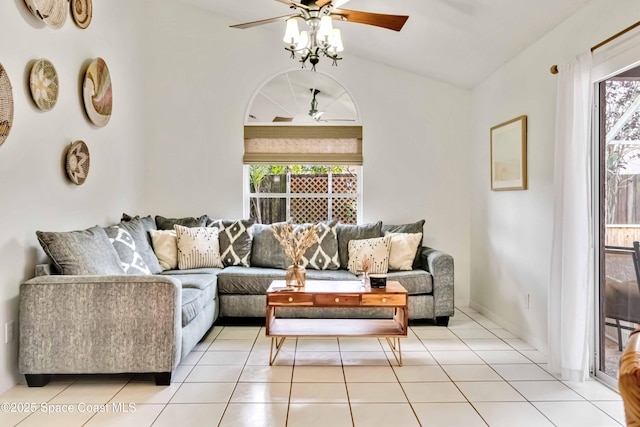 living room with ceiling fan, vaulted ceiling, and light tile patterned flooring