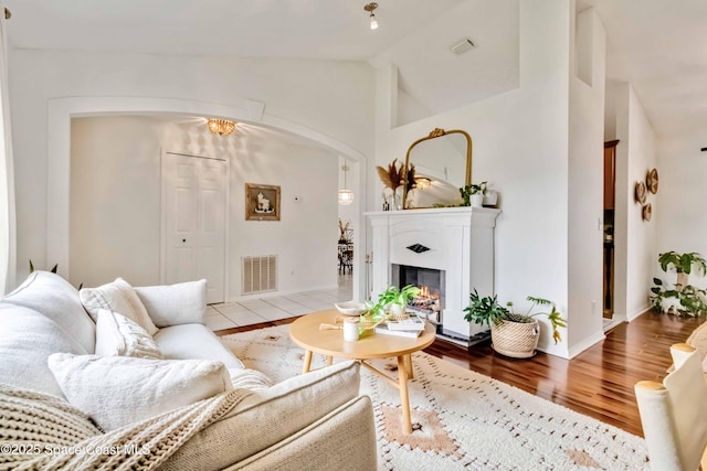 living room featuring vaulted ceiling and light hardwood / wood-style flooring