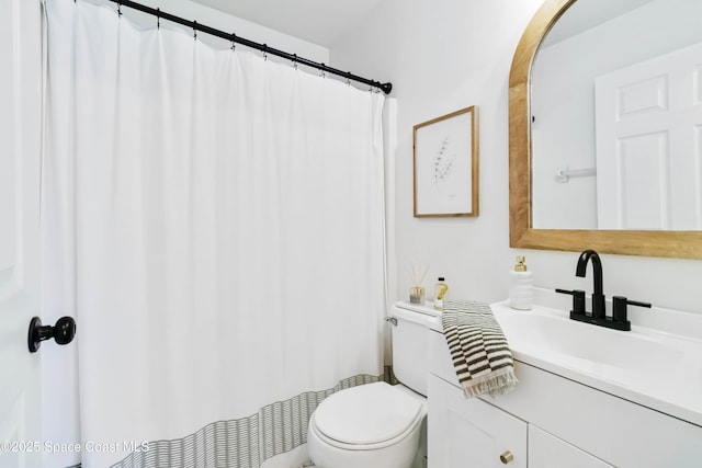 bathroom featuring toilet and vanity