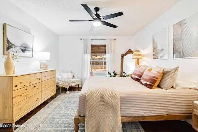 bedroom with ceiling fan and a textured ceiling