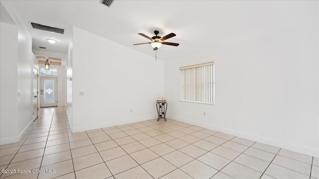 tiled spare room with ceiling fan