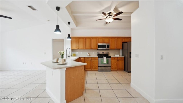 kitchen with kitchen peninsula, stainless steel appliances, light tile patterned floors, and pendant lighting