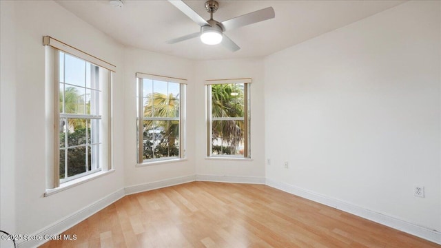 empty room featuring ceiling fan and light hardwood / wood-style flooring