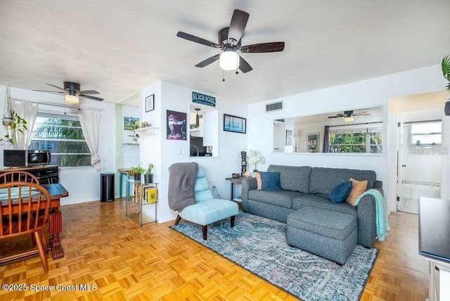 living room with visible vents and baseboards