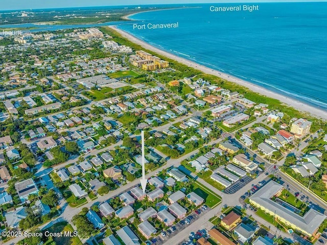 bird's eye view with a water view and a beach view