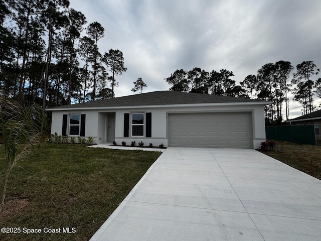 ranch-style home featuring a garage and a front lawn