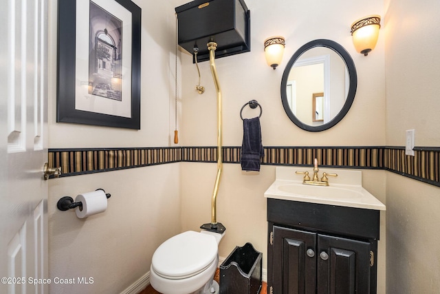 bathroom featuring toilet and vanity