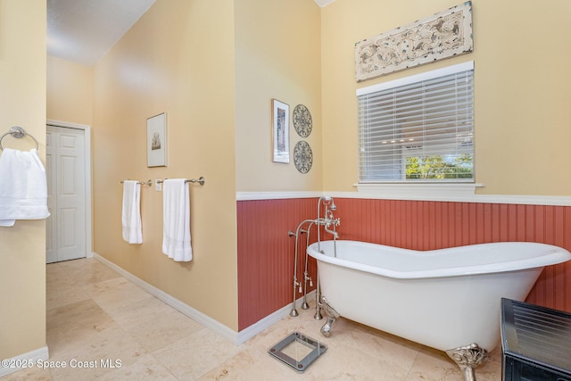 bathroom featuring wooden walls and a tub to relax in