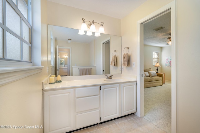 bathroom featuring tile patterned floors, vanity, a textured ceiling, and ceiling fan