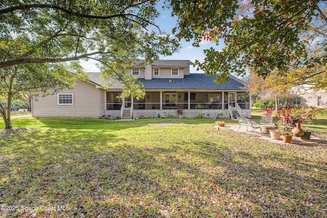 back of house featuring a patio area, a yard, and a sunroom